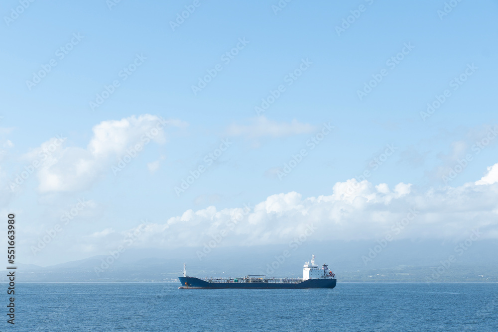 Empty Cargo ship moving along waters of Atlantic Ocean in the Caribbeans on a sunny day Empty Cargo ship moving along waters of Atlantic Ocean in the Caribbeans on a sunny day