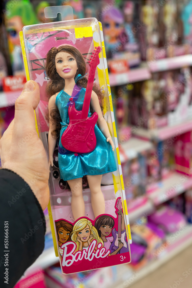 Barbie doll in the hand of a customer in a toy store. Barbie is a