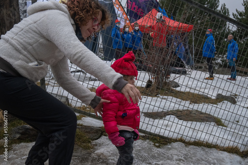 Mother and little daughter playing in the snow at Sierra Nevada Ski Resort