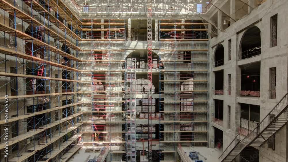 Panorama showing construction equipment material with scaffolding and tools inside the floor of high rising building timelapse, skyscraper. Building under construction. Interior work in progress. Panorama showing construction equipment material with scaffolding and tools inside the floor of high rising building timelapse, skyscraper. Building under construction. Interior work in progress.