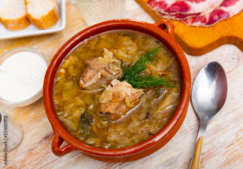 Traditional Russian dish is cabbage soup cooked in meat broth based on sauerkraut