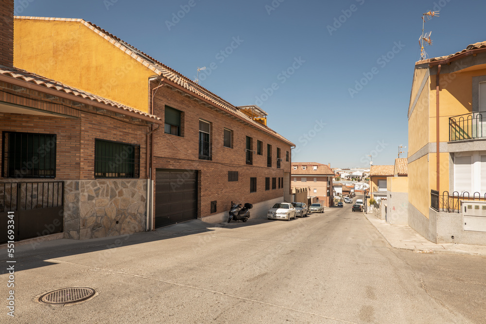 Facades of residential buildings in the street of a town on the outskirts of Madrid on a sunny day