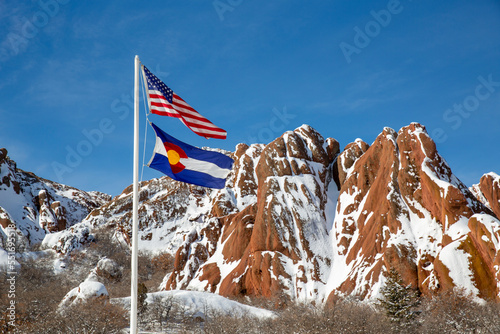 US flag in front of red rock formation at Roxborough State Park in Colorado in winter photo