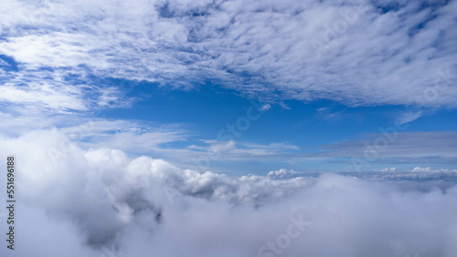Time lapse of beautiful sky scenery with clouds in the morning. Aerial view of clouds above the blue sky with the sun shining. View of the sea of mist on the mountain top. Sky nature background.