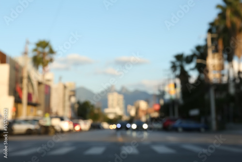 Blurred view of cityscape with cars on road. Bokeh effect