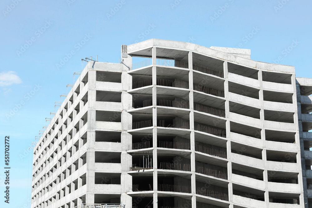 Construction site with unfinished building on sunny day