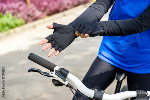 Woman wearing a gloves preparing for the bike ride