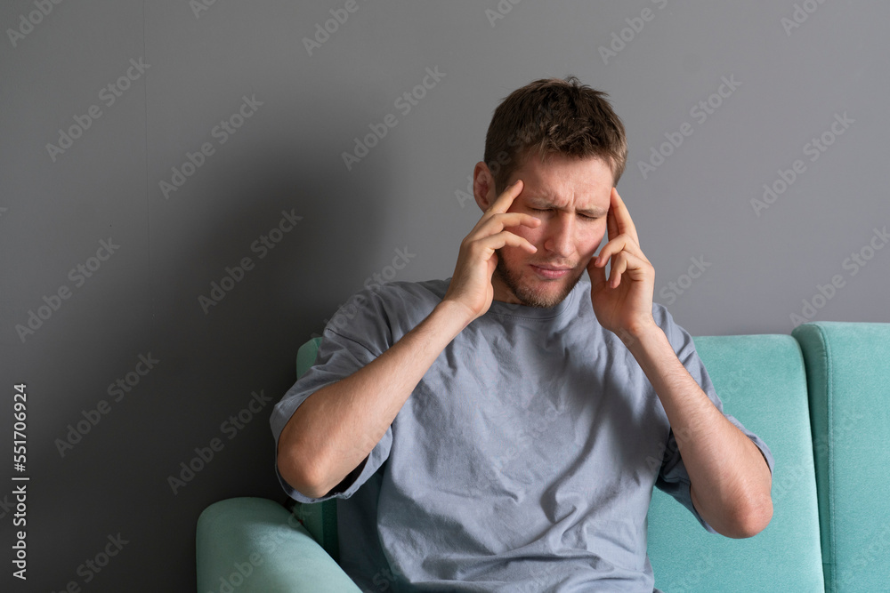 person feeling headache and touching head with his hand person feeling headache and touching head with his hand