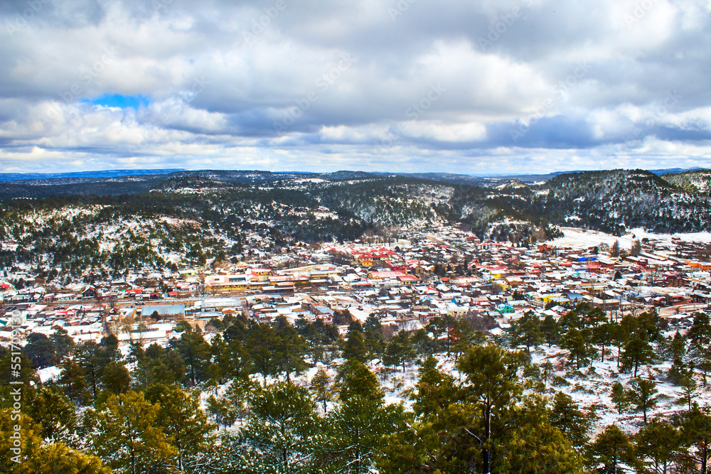 winter in village surrounded by mountains, snow covered the forest and hills, creel chihuahua 