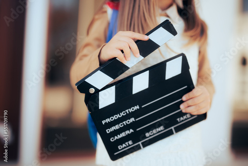 Toddler Girl Holding a Film Slate interested in Acting Lessons. Little wannabe female director holding a film slate

