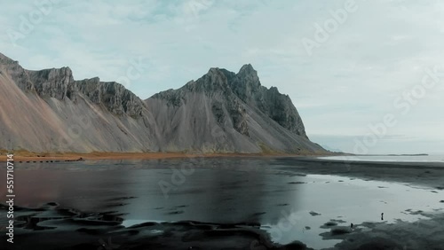 Natural beauty of Stokksnes black sand beach next to rugged Vestrahorn mountain photo