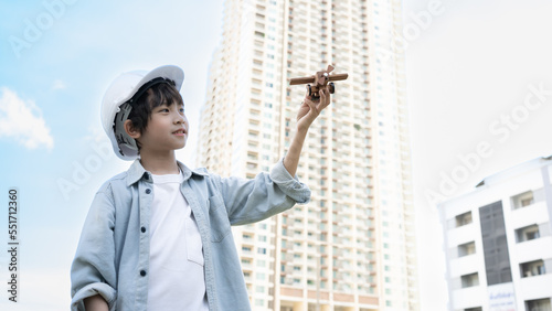 Asian Child pilot aviator with airplane dreams of traveling in city scape. Kids dream to be a Pilot, engine engineering. Future study development follow child's talent.