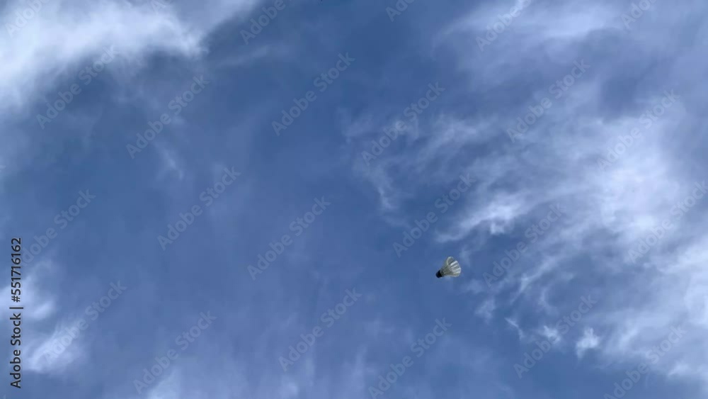 the background of the bright blue sky that is passed by the shuttlecock path. the concept of playing badminton outdoors the background of the bright blue sky that is passed by the shuttlecock path. the concept of playing badminton outdoors