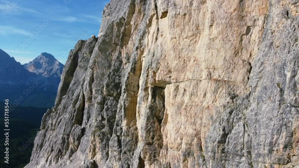 aerial of jagged rocks on side of Dolomite Mountain on sunny summer day