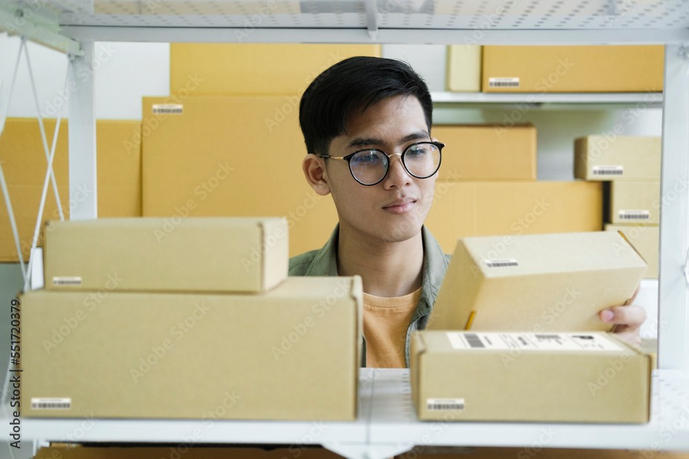 Online store owner checking orders for packaged product.
