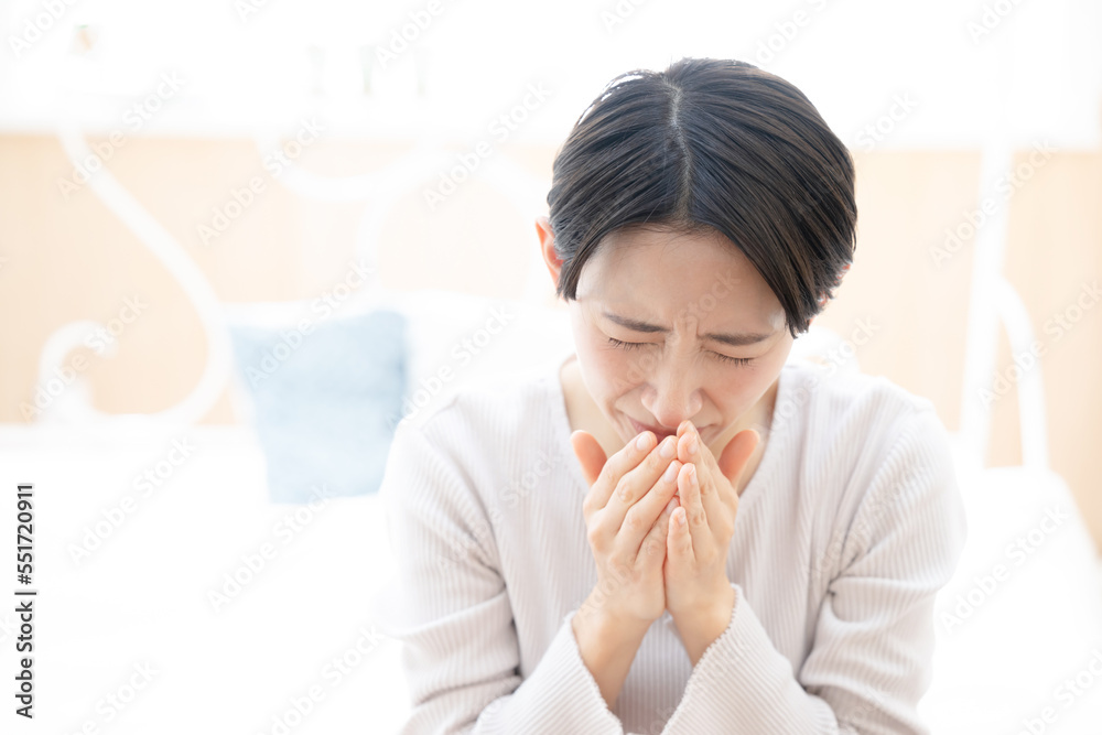 Sneezing Asian woman with a cold Sneezing Asian woman with a cold