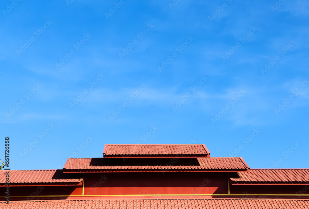 Red roof Thai temple on bright blue sky with space on background Red roof Thai temple on bright blue sky with space on background