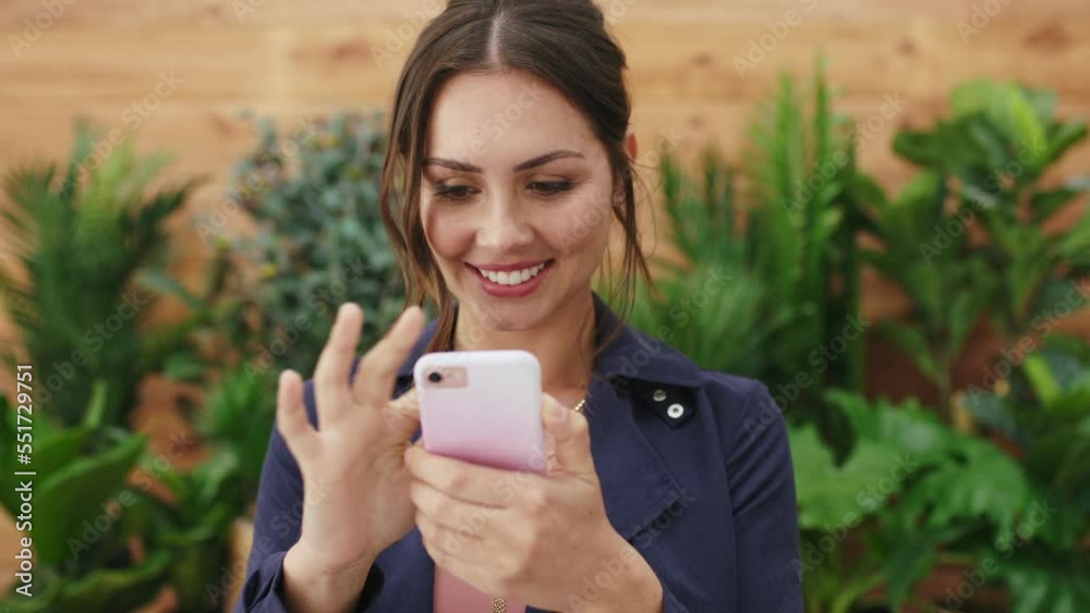 Phone, social media and communication with a business woman in an eco friendly office for networking. Mobile, search and internet with a female employee typing a text message in a green business Phone, social media and communication with a business woman in an eco friendly office for networking. Mobile, search and internet with a female employee typing a text message in a green business