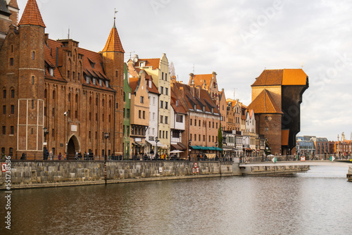 Ancient crane - zuraw Old town in Gdansk. The riverside on Granary Island reflection in Moltawa River. Visit Gdansk Poland Travel destination. Tourist attraction photo