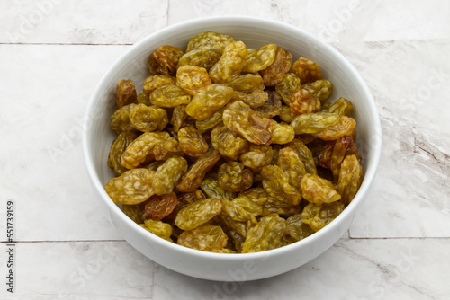 Dried Raisins in a bowl isolated on clear background. Diet food concept