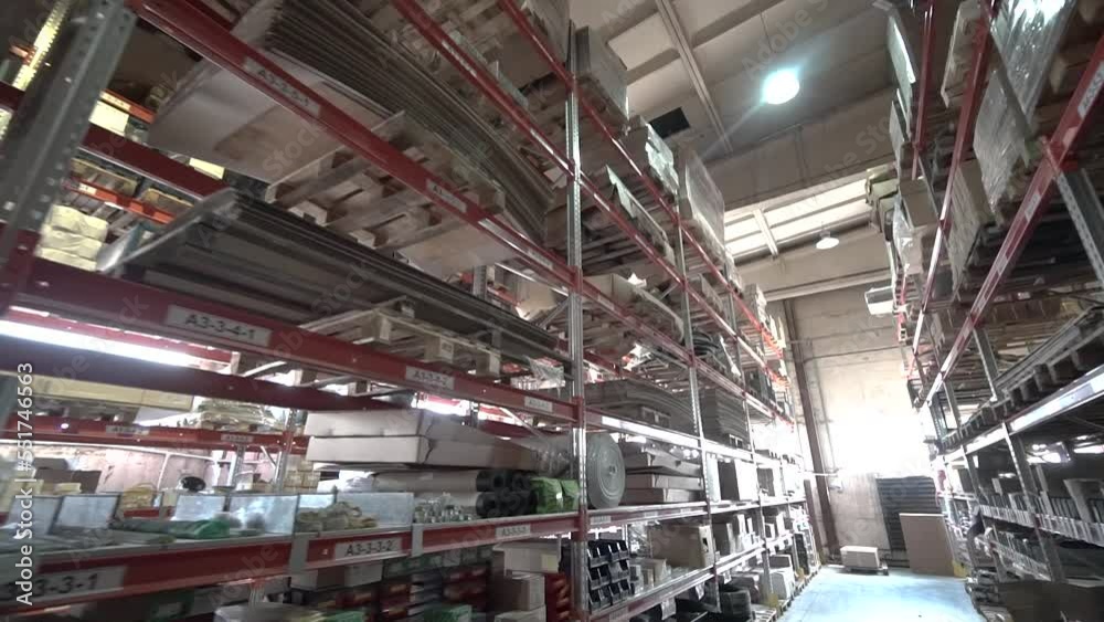 large factory warehouse. store aisles. The camera pans between shelves inside a large store. Delivery to the warehouse. Logistics business and forklift truck to move boxes and goods. freight mail large factory warehouse. store aisles. The camera pans between shelves inside a large store. Delivery to the warehouse. Logistics business and forklift truck to move boxes and goods. freight mail