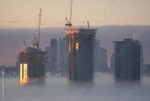 A thick fog blanket covering Metro Vancouver on a winter morning during sunrise in Burnaby, British Columbia, Canada photo