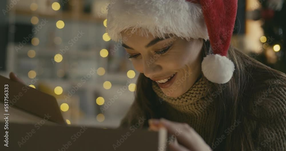 Happy young woman opening a Christmas present box