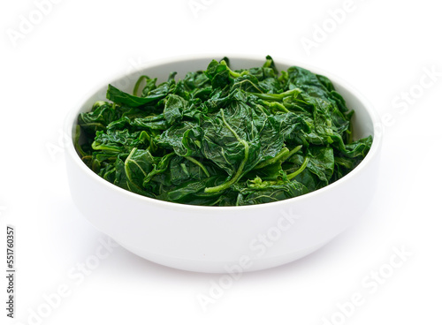 pile of green cook leaf spinach in white bowl isolated on white background. leaves spinach or heap of spinach isolated                                                    