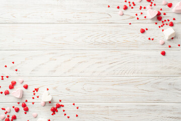 Valentine's Day concept. Top view photo of heart shaped candies on white wooden table background with copyspace