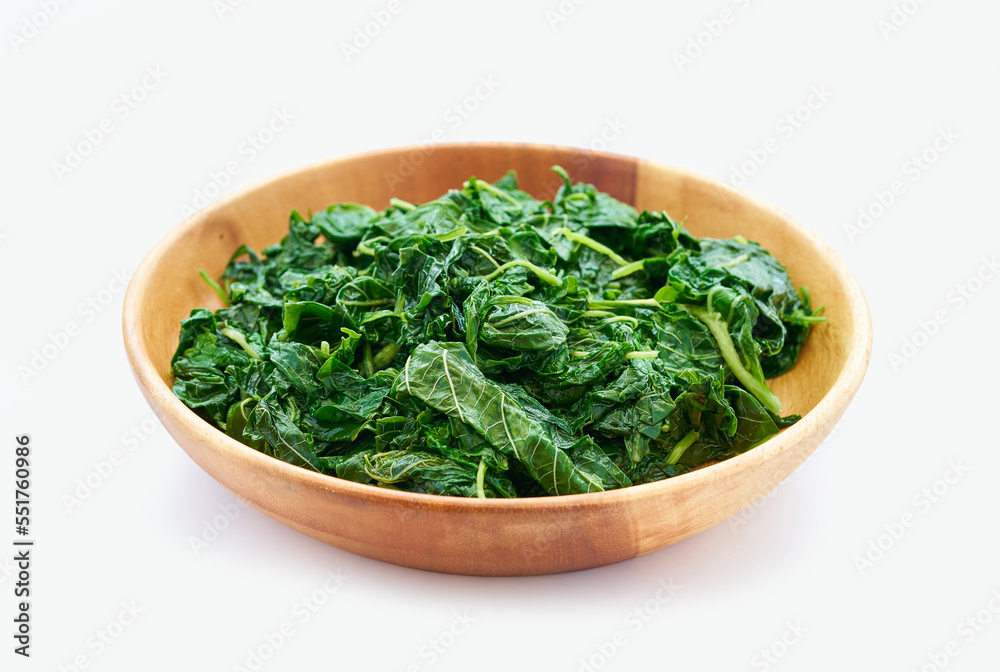 pile of green cook leaf spinach in wood bowl isolated on white background. leaves spinach or heap of spinach isolated pile of green cook leaf spinach in wood bowl isolated on white background. leaves spinach or heap of spinach isolated