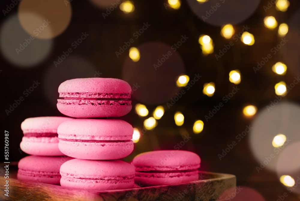 stack of macaroons on the table, fairy lights and bokeh background toned with viva magenta stack of macaroons on the table, fairy lights and bokeh background toned with viva magenta