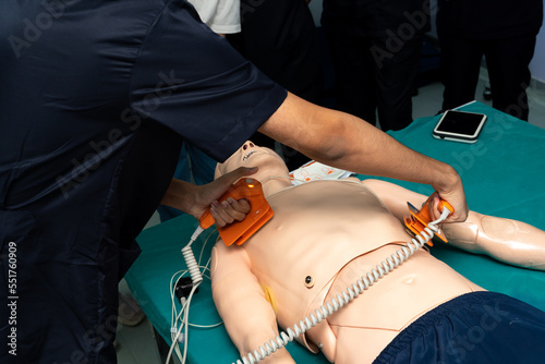doctor defibrillate dummy Exam doctors but emergency resuscitation. CPR Training in emergency refresher training to assist of physician.concept of saving lives.