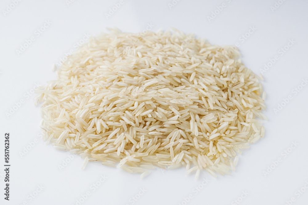 raw basmati rice on a white acrylic background raw basmati rice on a white acrylic background