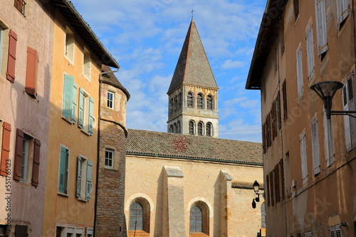 The external facade of Saint Philibert Abbey Church in Tournus, Burgundy, France, with historical house facades in the foreground. Picture taken from Fenelon street. photo