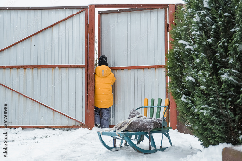 Winter games. Family playing snowballs in the courtyard of the house. winter, game, snow, christmas games, snow games, snowball fights, activity in winter,cottagecore,countryside