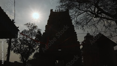 Point of view shining sun over dark ancient temple at kolar photo