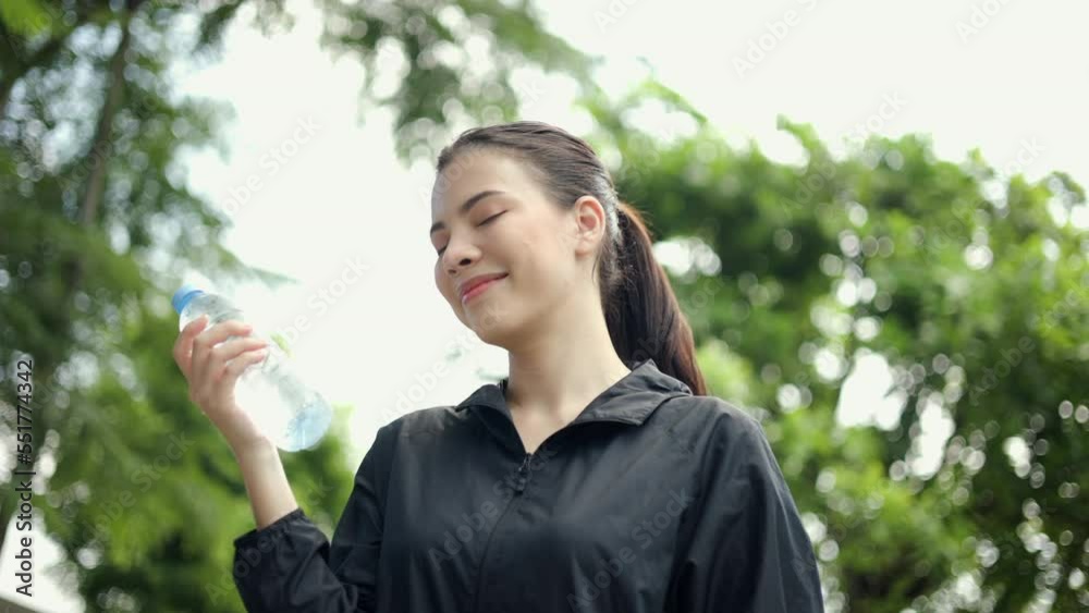 Portrait happy slim woman drinking water after workout exercising in the city at sunrise. Young beautiful female drinking water after jogging running outdoor. Healthy and active lifestyle concept. Portrait happy slim woman drinking water after workout exercising in the city at sunrise. Young beautiful female drinking water after jogging running outdoor. Healthy and active lifestyle concept.