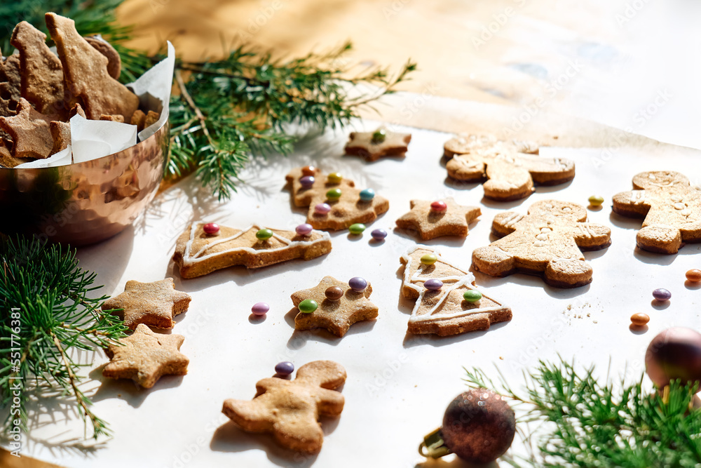 Glazed christmas gingerbread cookies a shape of gingerbread man,christmas tree and star,decorated with colorful sugared almonds.Baking homemade pastries.Christmas and New Year traditions festive food.