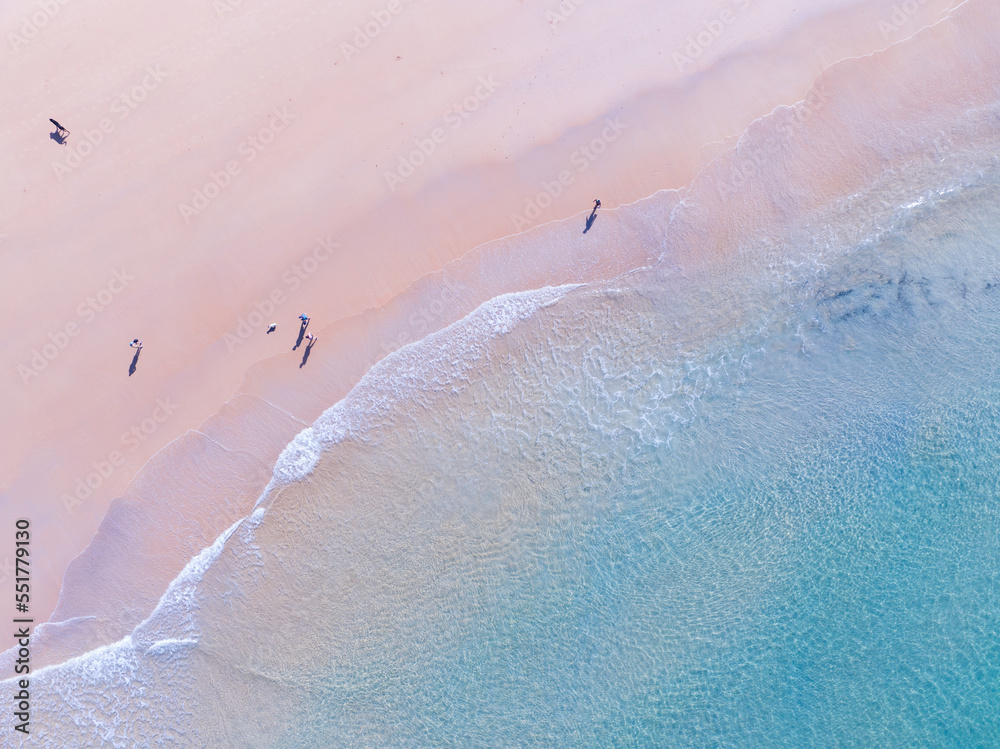 Top view of beach sea surface, Shot in the open sea from above,Amazing nature beach background, Turquoise Water surface waves reflecting the Sunlight