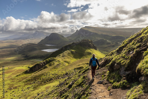 Woman hiking on Quiraing.It is a geological formation on the Scottish Isle of Skye and a hiker's paradise