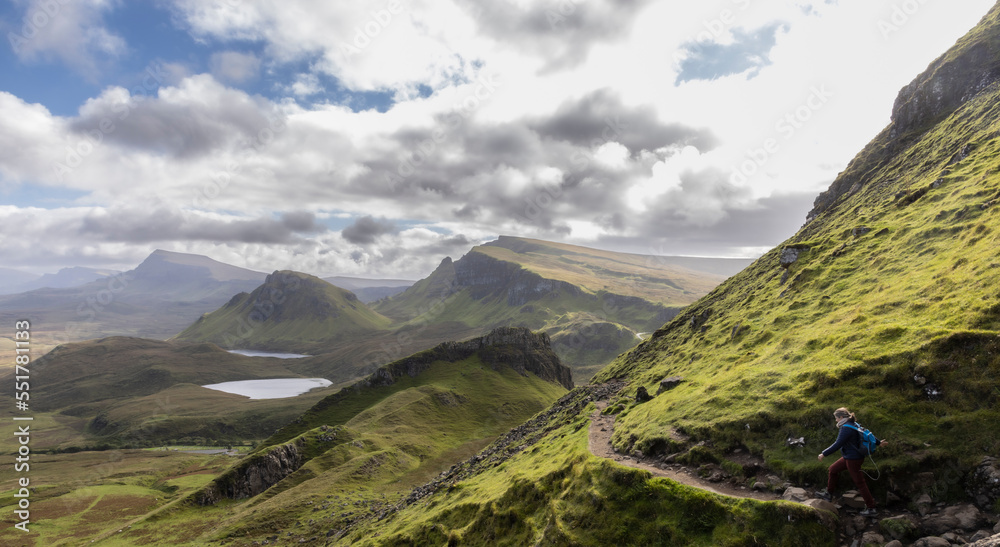 Woman hiking on Quiraing.It is a geological formation on the Scottish Isle of Skye and a hiker's paradise