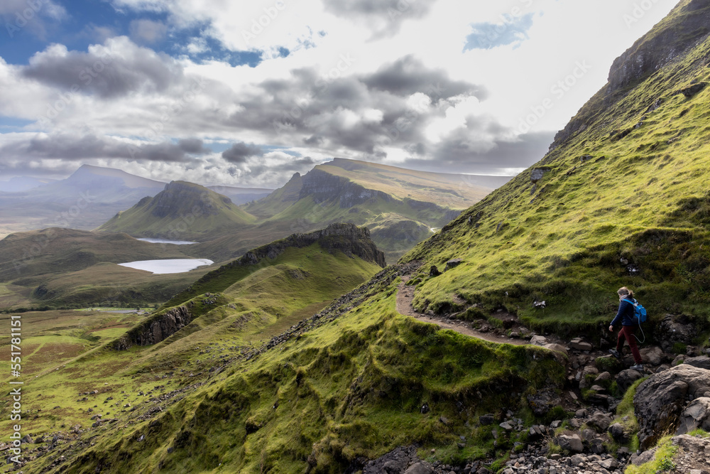 Woman hiking on Quiraing.It is a geological formation on the Scottish Isle of Skye and a hiker's paradise