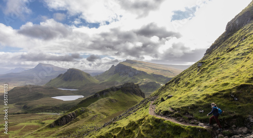 Obraz na płótnie Woman hiking on Quiraing.It is a geological formation on the Scottish Isle of Skye and a hiker's paradise w salonie