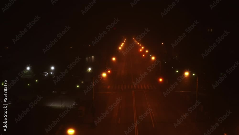 Spooky road and street lights at night with an empty road. Romania, Cluj-Napoca, Romania. Foggy night, Aerial. Spooky road and street lights at night with an empty road. Romania, Cluj-Napoca, Romania. Foggy night, Aerial.