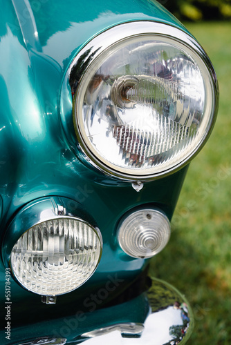 Turn signal and headlight of a retro green car