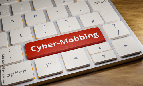 Cyber-Mobbing. Close-up computer keyboard. One key is red with the word cyber-mobbing. Internet offense, social media issue, shitstorm, insulting, hate and online behavior issues. 3D illustration photo