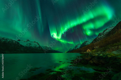 Lonely boat house under aurora borealis near Tromso, Norway