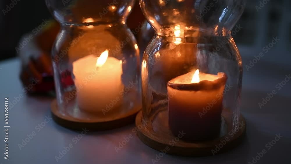 Three candles in jars on living room table, a boy playing with toy car in background Three candles in jars on living room table, a boy playing with toy car in background