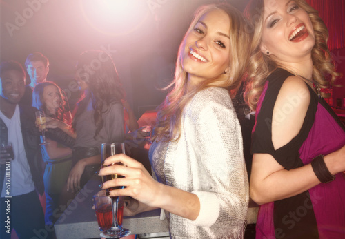 Woman, party portrait and champagne to celebrate birthday, new years or social event in nightclub together, Happiness, support and friends laughing in nightclub for friendship celebration with drink