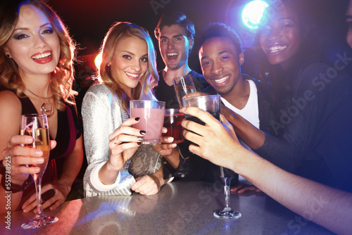 Canvas Print Friends with cocktail drinks, toast in nightclub and smile in party portrait, new year celebration with happy people